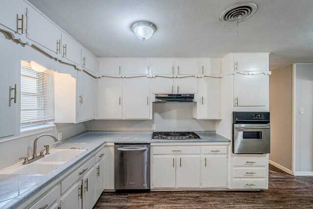 5729 Wales Ave, Fort Worth, TX 76133 - kitchen with stainless steel appliances, dark wood finished floors, white cabinets, a sink, and under cabinet range hood