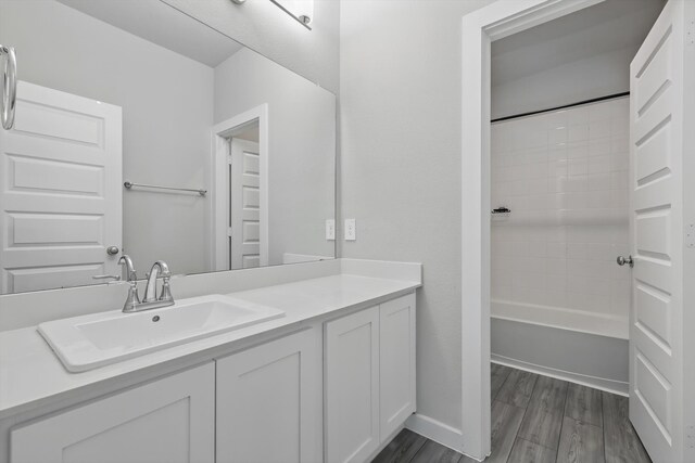 2321 Spring Side Dr, Royse City, TX 75189 - bathroom with vanity, wood finished floors, and tub / shower combination