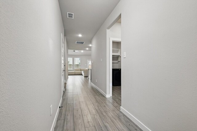 2321 Spring Side Dr, Royse City, TX 75189 - hall featuring light wood-style floors, baseboards, recessed lighting, and a textured wall