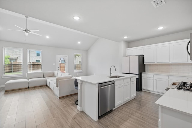 2321 Spring Side Dr, Royse City, TX 75189 - kitchen with stainless steel dishwasher, a sink, vaulted ceiling, freestanding refrigerator, and open floor plan