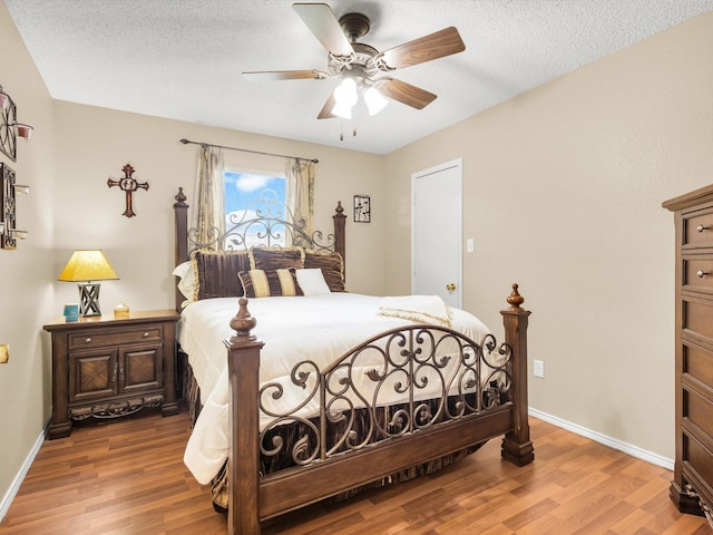 10117 High Bluff Dr, Fort Worth, TX 76108 - bedroom featuring wood finished floors, baseboards, a textured ceiling, and a ceiling fan