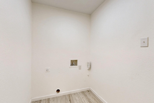 3558 La Prada Dr, Mesquite, TX 75150 - laundry room with electric dryer hookup, washer hookup, light wood-type flooring, baseboards, and gas dryer hookup