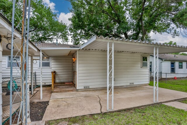 501 Lynch St, Gainesville, TX 76240 - rear view of property featuring crawl space, a patio, and a carport