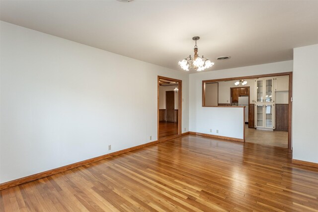501 Lynch St, Gainesville, TX 76240 - unfurnished room featuring a chandelier, light wood-type flooring, and baseboards
