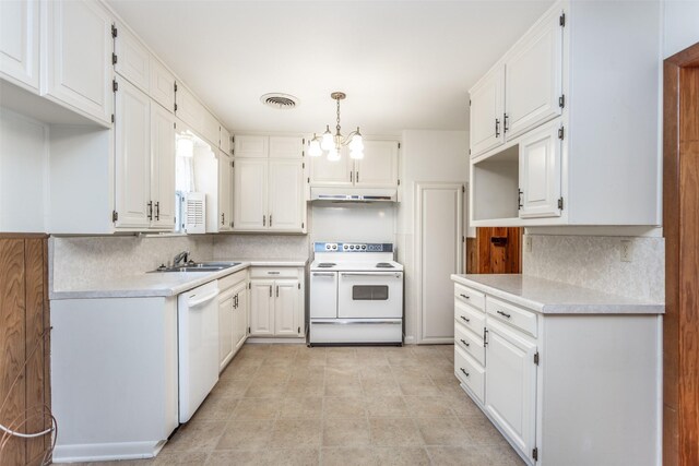 501 Lynch St, Gainesville, TX 76240 - kitchen with white appliances, a sink, decorative backsplash, and white cabinets