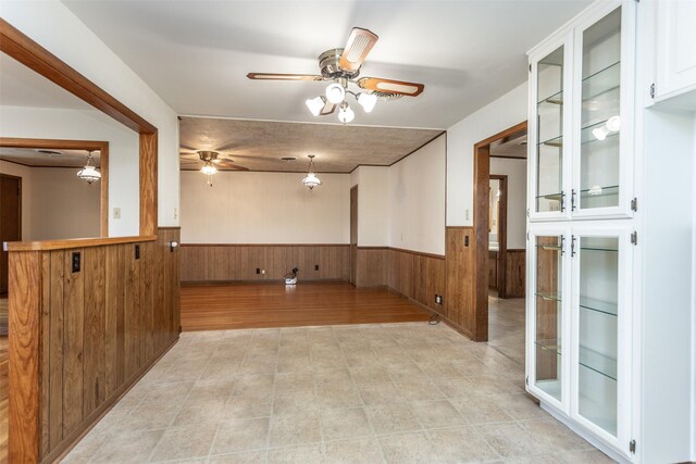 501 Lynch St, Gainesville, TX 76240 - unfurnished room featuring a wainscoted wall, ceiling fan, and wooden walls