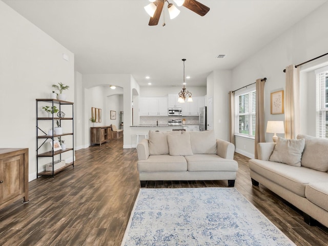 11716 Pistachio Trl, Fort Worth, TX 76108 - living area with dark wood-style floors, ceiling fan, baseboards, recessed lighting, and arched walkways