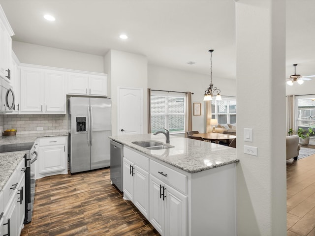 11716 Pistachio Trl, Fort Worth, TX 76108 - kitchen with appliances with stainless steel finishes, a sink, dark wood-type flooring, decorative backsplash, and recessed lighting