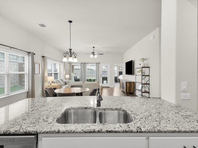 11716 Pistachio Trl, Fort Worth, TX 76108 - kitchen with open floor plan, a sink, a ceiling fan, light stone countertops, and dishwashing machine