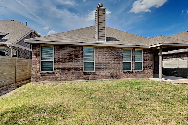 928 Dove Cv, Argyle, TX 76226 - back of property with brick siding, a patio area, a chimney, and a shingled roof