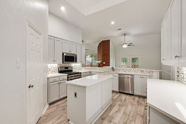 1401 Superior Dr, Flower Mound, TX 75028 - kitchen with appliances with stainless steel finishes, a sink, a ceiling fan, backsplash, and light wood-style floors