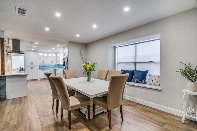 1316 Devonshire Ln, Mesquite, TX 75150 - dining room with light wood finished floors, recessed lighting, baseboards, and a textured wall