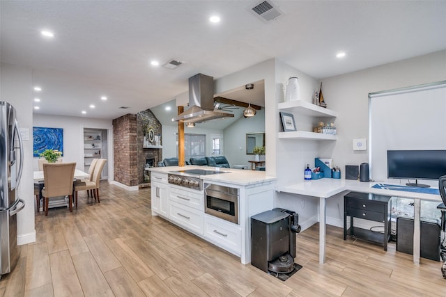 1316 Devonshire Ln, Mesquite, TX 75150 - kitchen featuring stainless steel appliances, open floor plan, island range hood, white cabinetry, and light wood-style floors