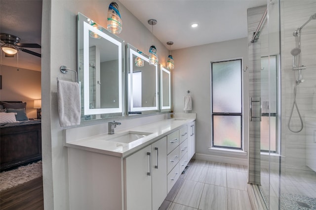 1316 Devonshire Ln, Mesquite, TX 75150 - ensuite bathroom with ceiling fan, double vanity, tiled shower, healthy amount of natural light, and recessed lighting