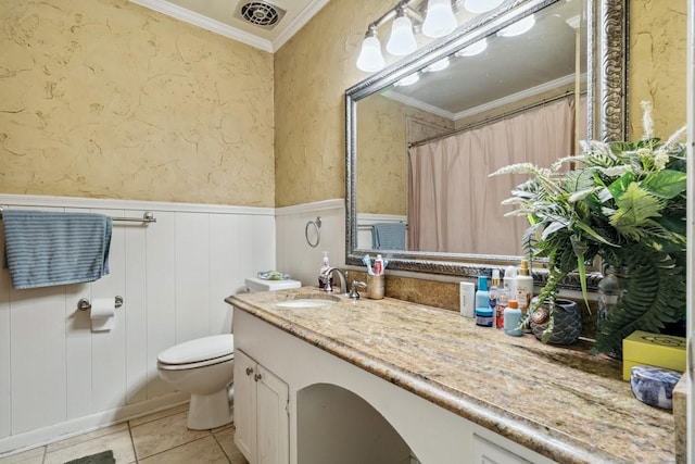 2916 Lafayette St, Corsicana, TX 75110 - bathroom featuring ornamental molding, vanity, toilet, wainscoting, and tile patterned flooring