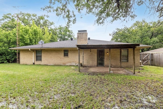 2916 Lafayette St, Corsicana, TX 75110 - back of property with a patio, a chimney, and brick siding
