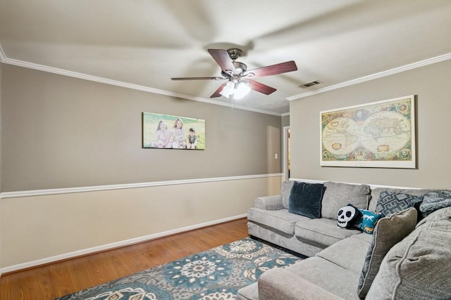 2916 Lafayette St, Corsicana, TX 75110 - living area featuring wood finished floors, ornamental molding, ceiling fan, and baseboards
