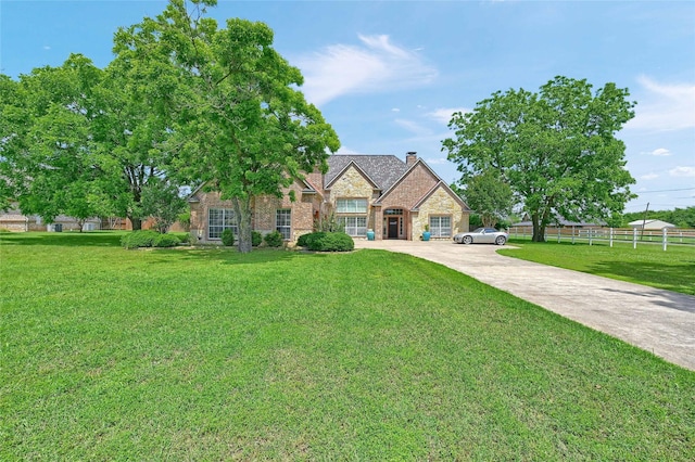 30 Tananger Springs Dr, Denison, TX 75021 - view of front of house with stone siding, a chimney, and concrete driveway