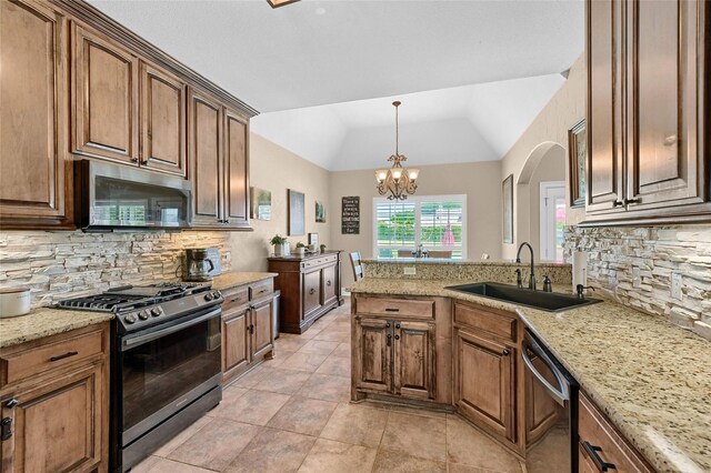 30 Tananger Springs Dr, Denison, TX 75021 - kitchen with stainless steel appliances, a sink, decorative backsplash, lofted ceiling, and a chandelier
