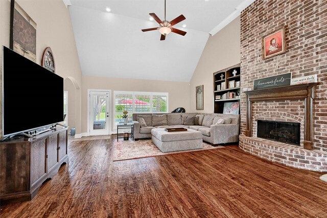 30 Tananger Springs Dr, Denison, TX 75021 - living room featuring high vaulted ceiling, a brick fireplace, built in shelves, ceiling fan, and wood finished floors