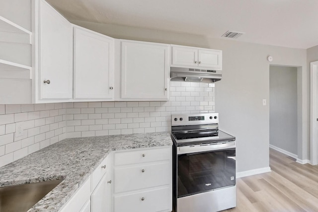2530 Gerry Way St, Lancaster, TX 75134 - kitchen with stainless steel range with electric stovetop, under cabinet range hood, open shelves, and white cabinets