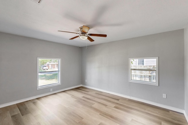 2530 Gerry Way St, Lancaster, TX 75134 - empty room featuring a ceiling fan, light wood-style floors, and baseboards