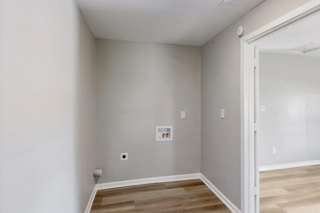 2530 Gerry Way St, Lancaster, TX 75134 - laundry area featuring washer hookup, wood finished floors, electric dryer hookup, and baseboards