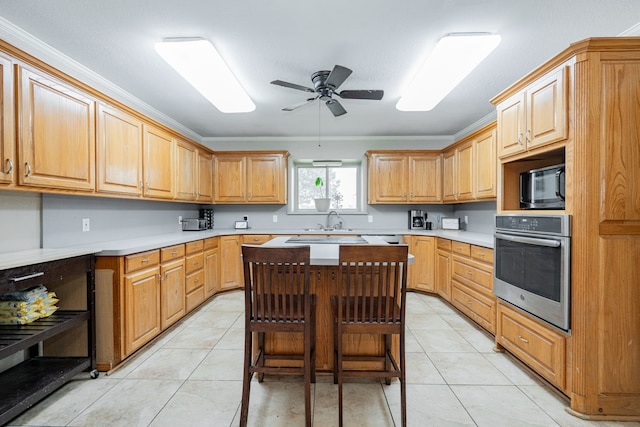 9390 Adams St, Terrell, TX 75160 - kitchen featuring stainless steel oven, a sink, a ceiling fan, and light countertops
