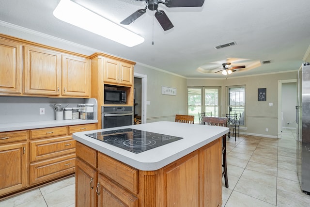 9390 Adams St, Terrell, TX 75160 - kitchen featuring black appliances, a ceiling fan, a center island, a breakfast bar area, and light countertops