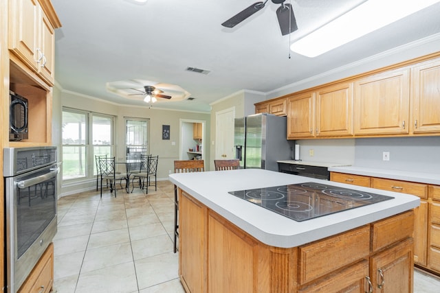 9390 Adams St, Terrell, TX 75160 - kitchen with ceiling fan, black appliances, a center island, crown molding, and light tile patterned floors