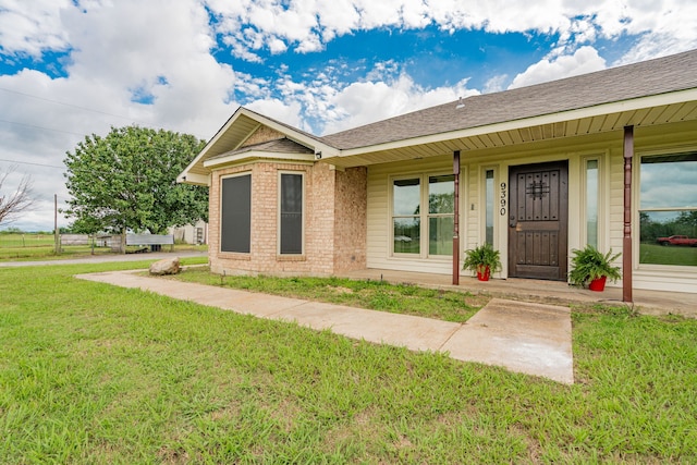 9390 Adams St, Terrell, TX 75160 - single story home with covered porch, a front lawn, brick siding, and a shingled roof