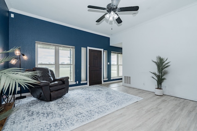 9390 Adams St, Terrell, TX 75160 - living area with wood finished floors, ornamental molding, a ceiling fan, and baseboards