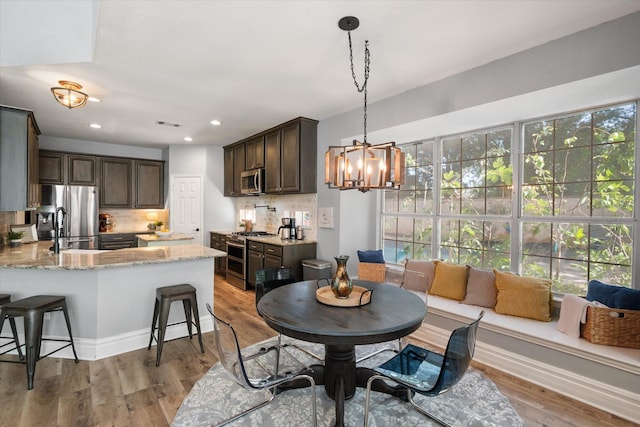 4710 Safe Harbour Dr, Arlington, TX 76016 - dining room featuring a chandelier, light wood-style flooring, and recessed lighting