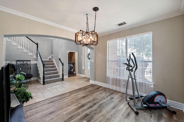4710 Safe Harbour Dr, Arlington, TX 76016 - exercise room featuring washer / dryer, arched walkways, crown molding, wood finished floors, and baseboards