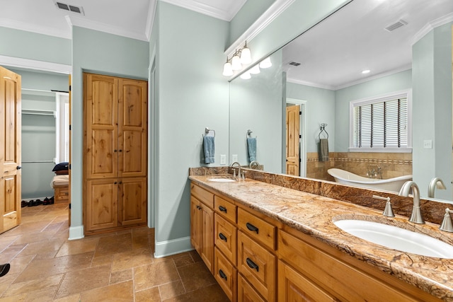 12265 Sable Ln, Whitehouse, TX 75791 - bathroom with a closet, double vanity, a bathtub, crown molding, and baseboards