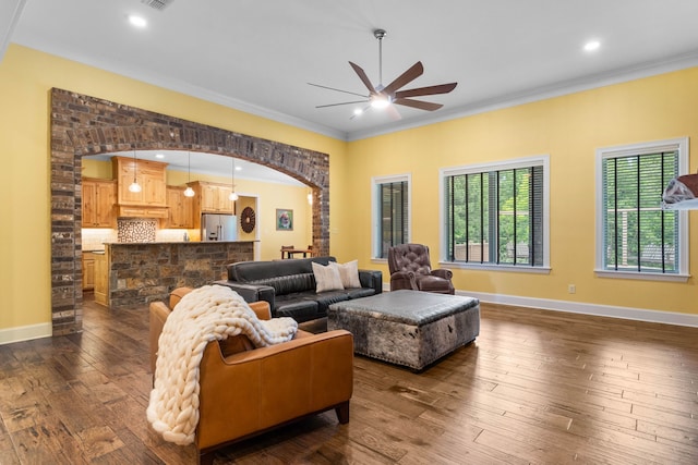 12265 Sable Ln, Whitehouse, TX 75791 - living room featuring a ceiling fan, crown molding, arched walkways, dark wood-style floors, and baseboards