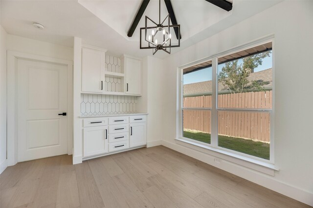 3620 Big Horn Trl, Plano, TX 75075 - unfurnished dining area with light wood-type flooring, a chandelier, and baseboards