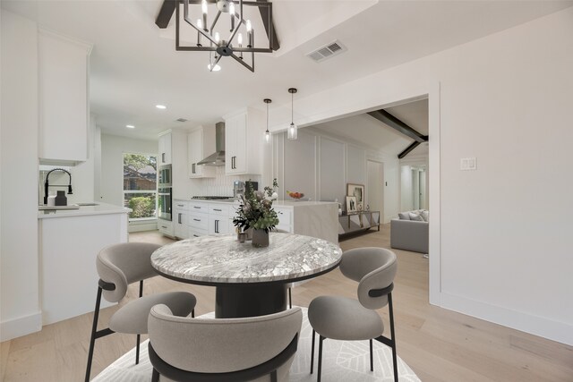 3620 Big Horn Trl, Plano, TX 75075 - dining space featuring light wood-style floors, a chandelier, baseboards, and vaulted ceiling