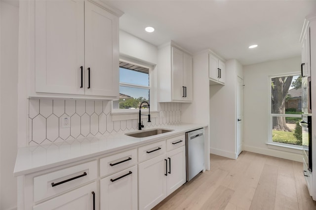 3620 Big Horn Trl, Plano, TX 75075 - kitchen featuring dishwasher, a sink, healthy amount of natural light, light wood-style floors, and recessed lighting