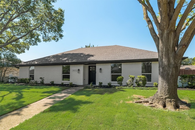 3620 Big Horn Trl, Plano, TX 75075 - view of front of home featuring brick siding, a front yard, and a shingled roof