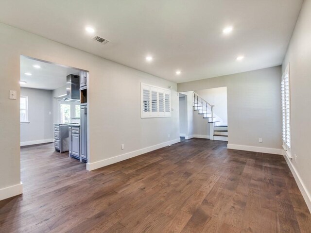 1135 La Mesa Dr, Richardson, TX 75080 - unfurnished living room featuring stairs, recessed lighting, dark wood-style flooring, and baseboards