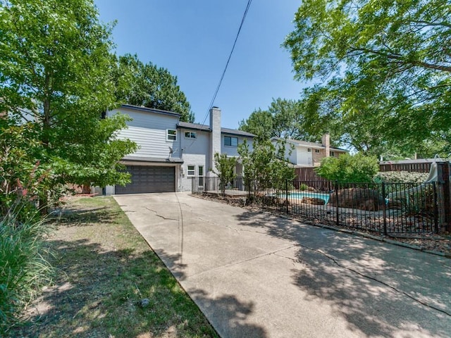 1135 La Mesa Dr, Richardson, TX 75080 - view of front facade featuring concrete driveway, a garage, and a chimney