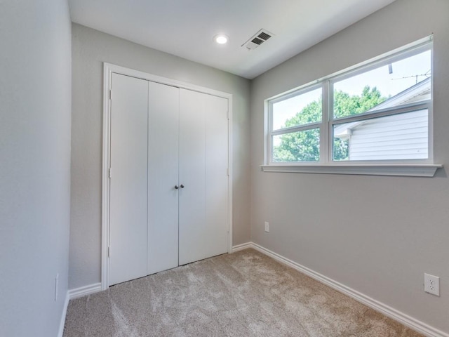 1135 La Mesa Dr, Richardson, TX 75080 - unfurnished bedroom featuring light carpet, baseboards, a closet, and recessed lighting