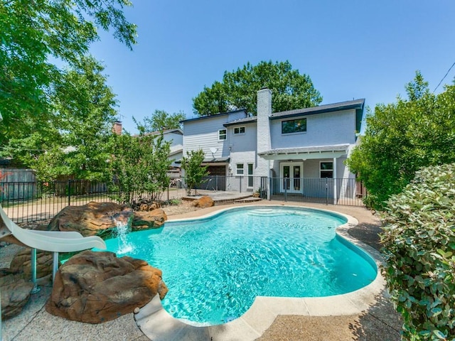 1135 La Mesa Dr, Richardson, TX 75080 - view of swimming pool with french doors, a fenced backyard, and a patio area