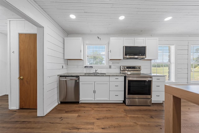 281 Private Road 612, Reagan, TX 76680 - kitchen with appliances with stainless steel finishes, white cabinets, dark wood-type flooring, wooden ceiling, and light stone counters