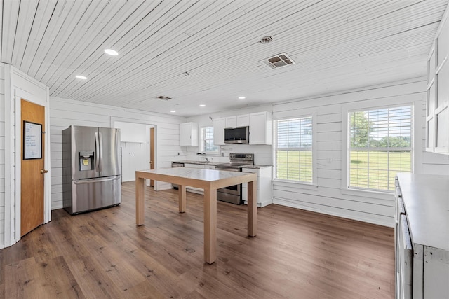 281 Private Road 612, Reagan, TX 76680 - kitchen with appliances with stainless steel finishes, wooden ceiling, white cabinets, dark wood finished floors, and light countertops