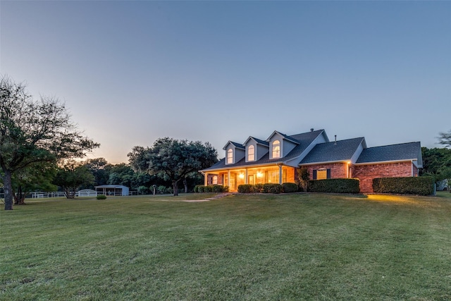 5891 Harmony Ranch Rd, Aubrey, TX 76227 - cape cod house featuring a yard and brick siding