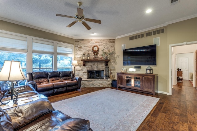 5891 Harmony Ranch Rd, Aubrey, TX 76227 - living room with ceiling fan, dark wood-style floors, ornamental molding, a stone fireplace, and a textured ceiling