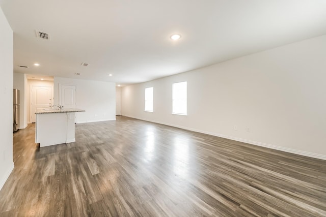 467 Bobbie St, Mabank, TX 75147 - unfurnished living room with baseboards, recessed lighting, a sink, and dark wood-style flooring