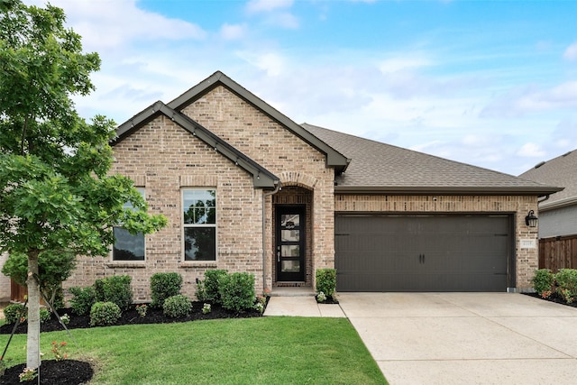 4105 Silver Spur Ct, Aubrey, TX 76227 - french country inspired facade with brick siding, an attached garage, driveway, and a front lawn